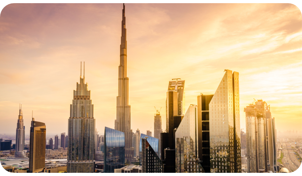 Photo of the Dubai skyline during the sunset, with the frame of the Burj Khalifa showing in the middle of the photo.